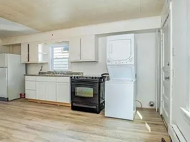 a kitchen with a refrigerator stove and white cabinets