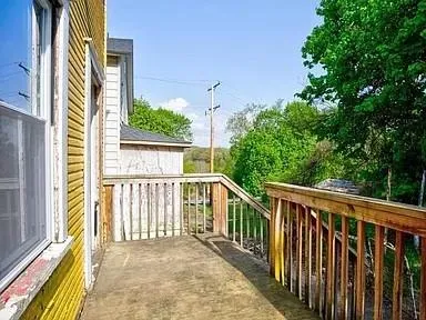a view of a balcony with wooden floor