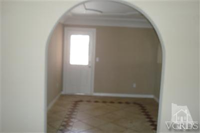 718 Teakwood Street Oxnard, CA 93033 - Photo 5 of 15 a view of an empty room with wooden floor and a window
