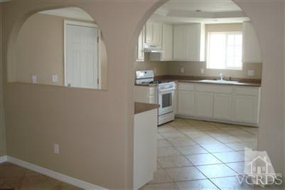 718 Teakwood Street Oxnard, CA 93033 - Photo 6 of 15 a kitchen with a stove a sink and a refrigerator