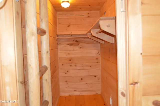 a bathroom with a sink a light fixture and a glass door shower