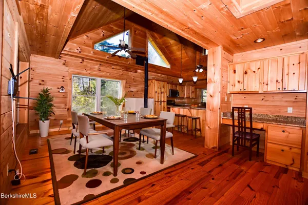 a kitchen with stainless steel appliances granite countertop a sink a stove and refrigerator