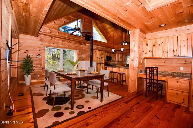 a kitchen with stainless steel appliances granite countertop a sink a stove and refrigerator