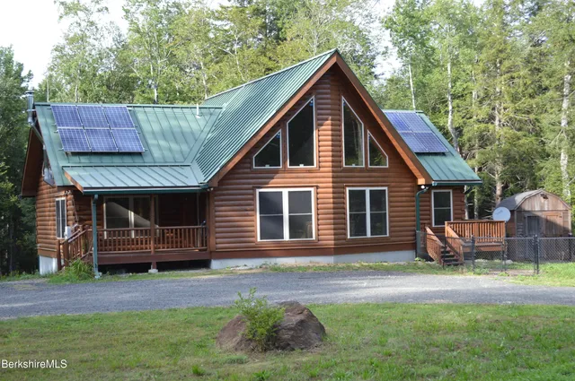 a kitchen with stainless steel appliances kitchen island granite countertop a sink window and cabinets