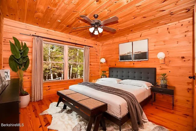 a bathroom with a granite countertop sink a mirror and shower