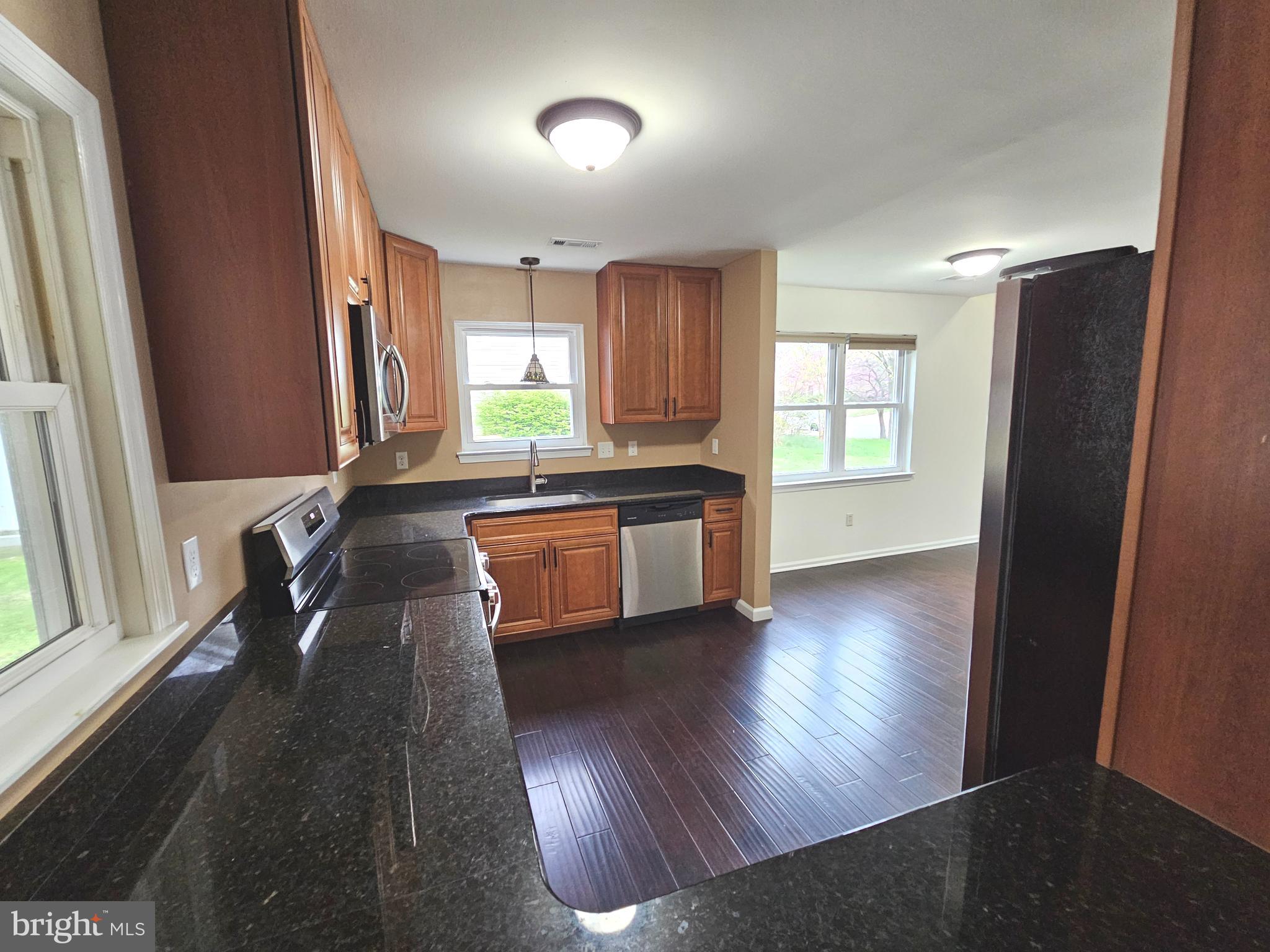 7 Gristmill Drive Dover, DE 19904 - Photo 11 of 26 a kitchen with sink cabinets and wooden floor