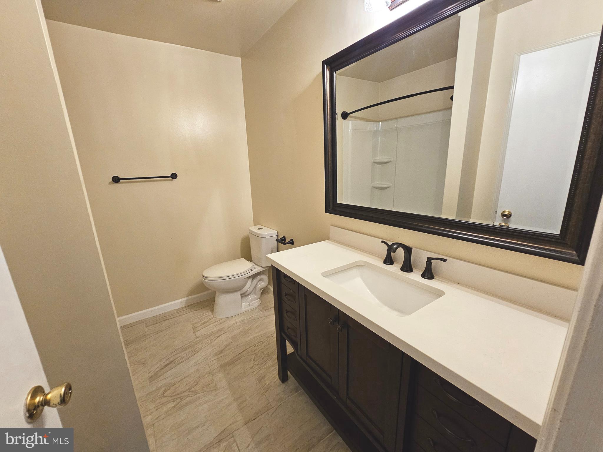 7 Gristmill Drive Dover, DE 19904 - Photo 13 of 26 a bathroom with a sink a toilet and a mirror