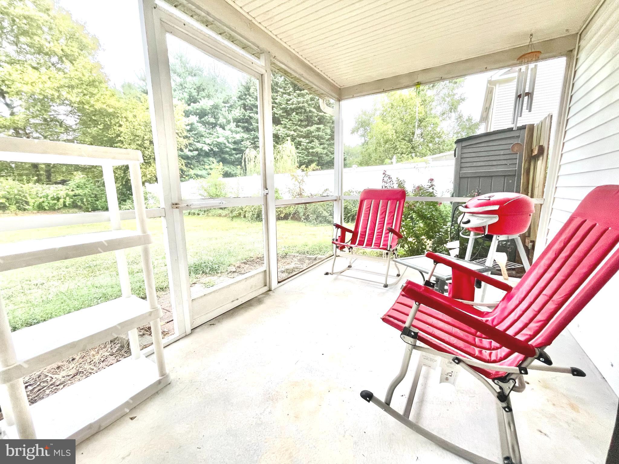 7 Gristmill Drive Dover, DE 19904 - Photo 24 of 26 a living room with a floor to ceiling window and a table