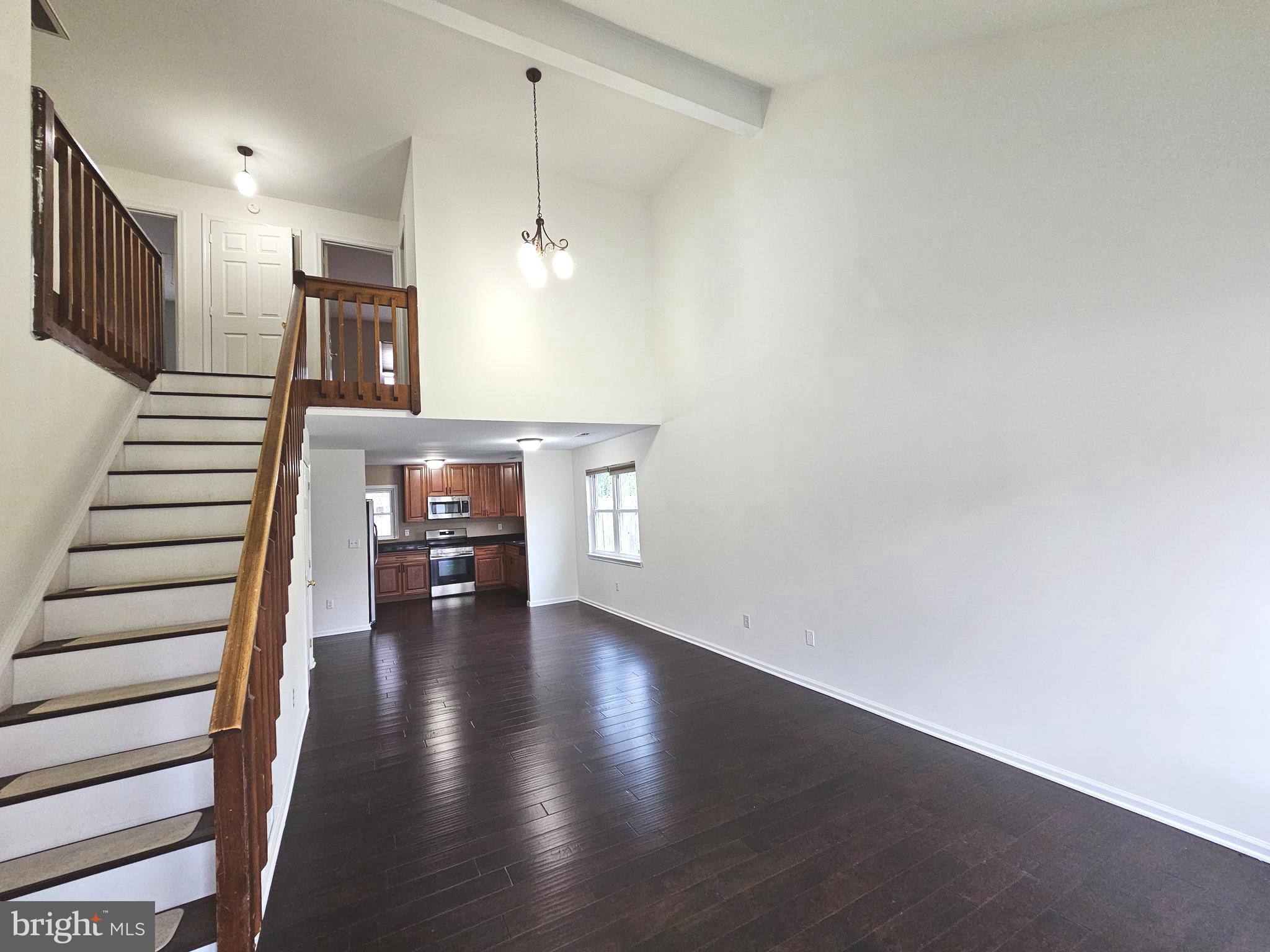 7 Gristmill Drive Dover, DE 19904 - Photo 4 of 26 a view of a hallway with wooden floor and staircase