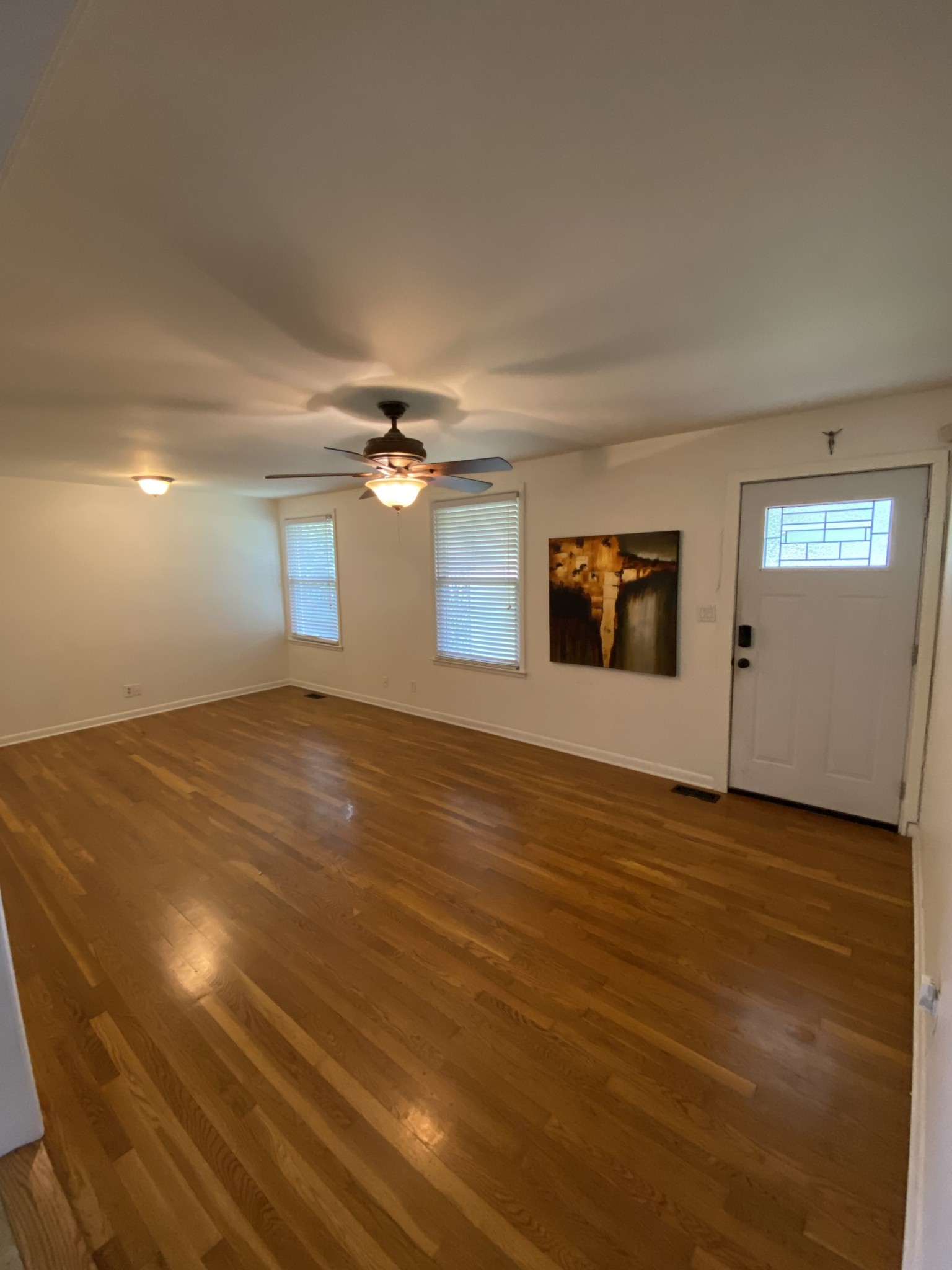 303 Gates Road Goodlettsville, TN 37072 - Photo 6 of 19 an empty room with wooden floor chandelier fan and windows