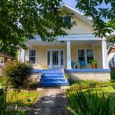 a view of a house with backyard and sitting area