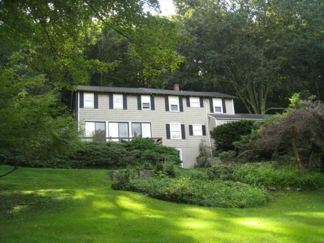 58 Horseshoe Road Wilton, CT 06897 - Photo 1 of 1 a front view of a house with a yard