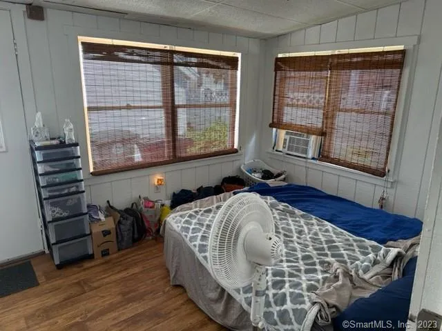 a bed sitting in a bedroom next to a window