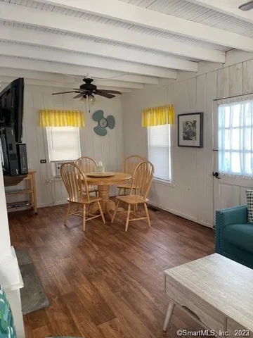 a dining room with furniture and window
