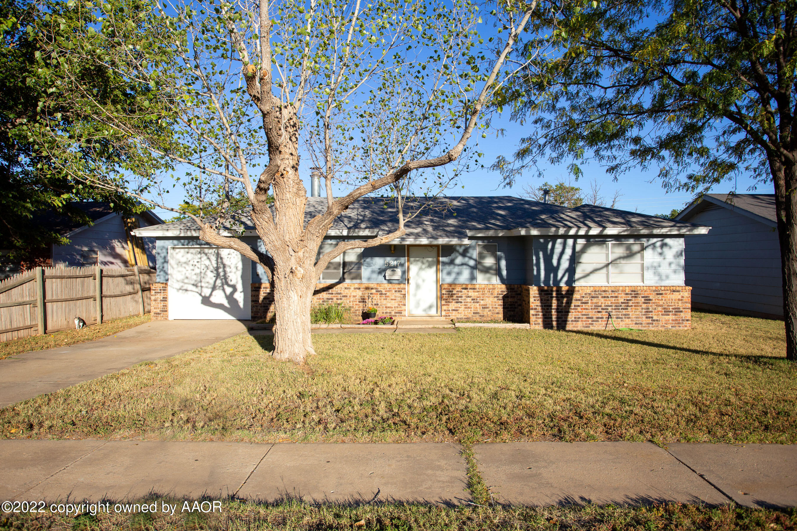 5217 South Travis Street Amarillo, TX 79110 - Photo 1 of 28 a view of a yard with wooden fence