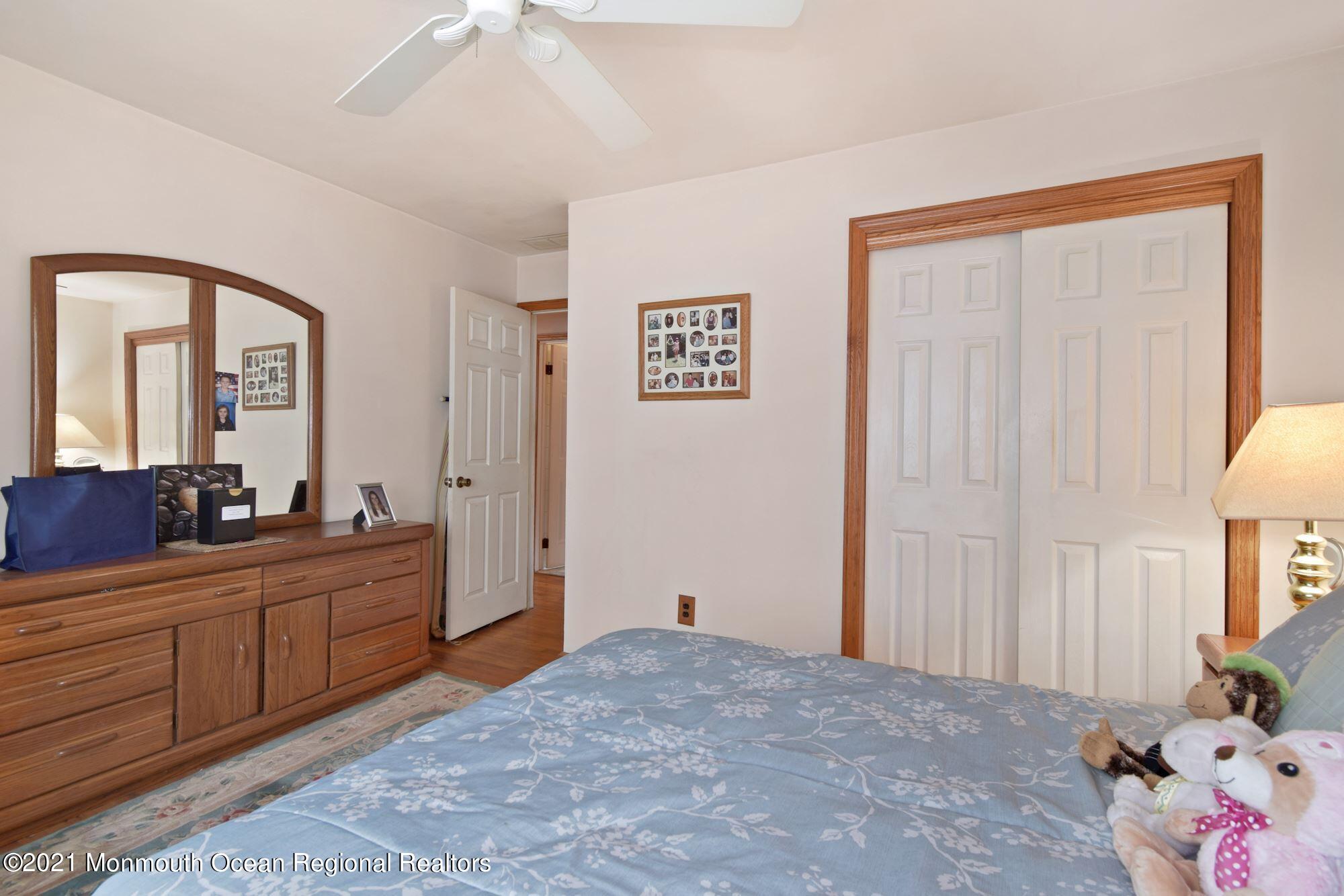 20 Bunkerhill Road Hazlet, NJ 07730 - Photo 13 of 27 a bedroom with a bed and a chandelier