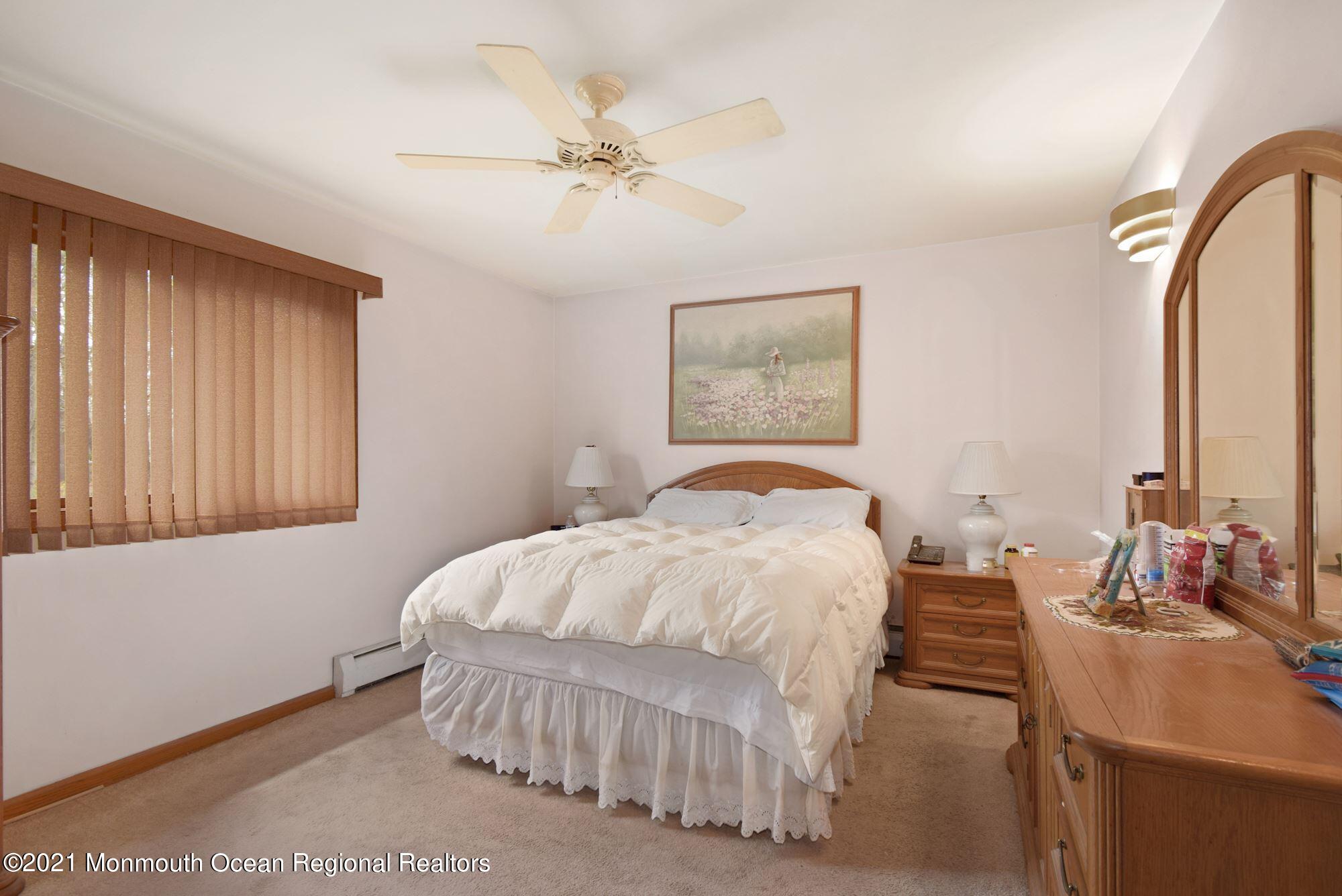 20 Bunkerhill Road Hazlet, NJ 07730 - Photo 14 of 27 a bedroom with a bed and a chandelier