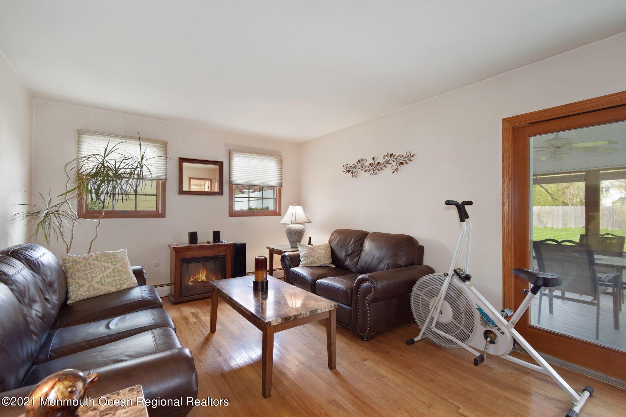 20 Bunkerhill Road Hazlet, NJ 07730 - Photo 16 of 27 a living room with furniture a wooden floor and a large window