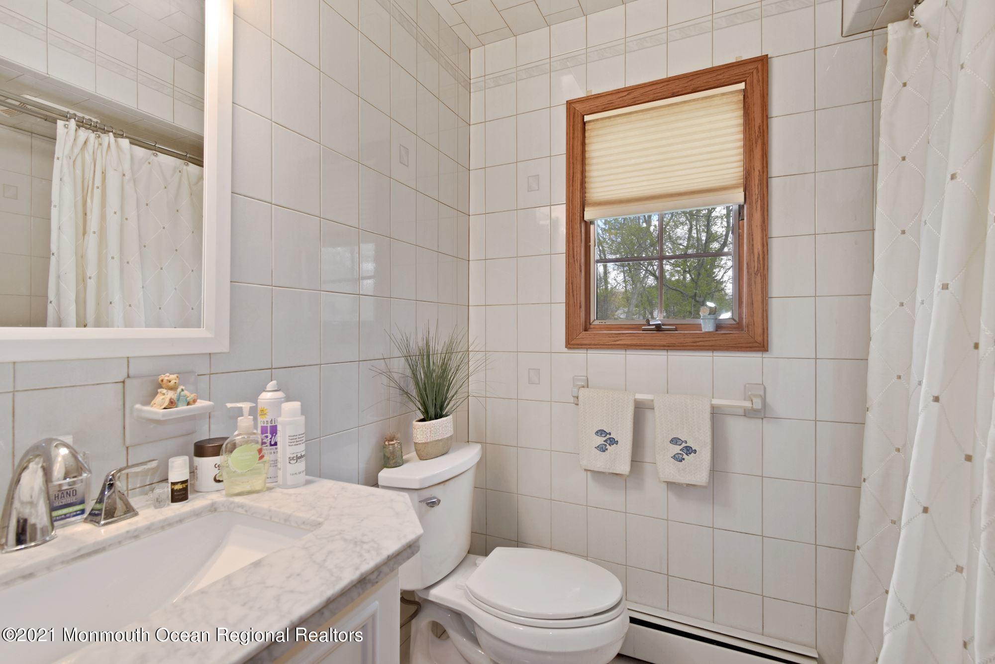 20 Bunkerhill Road Hazlet, NJ 07730 - Photo 18 of 27 a bathroom with a sink a toilet and tub