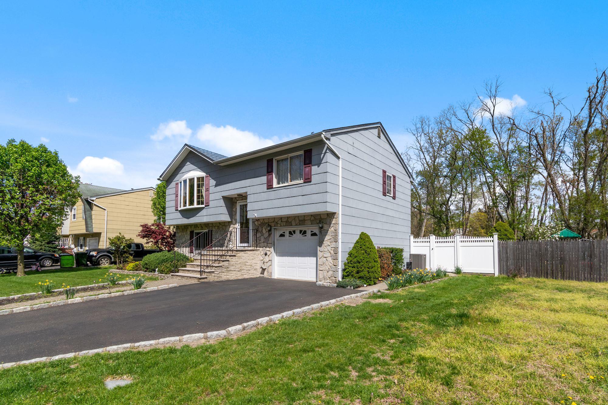 20 Bunkerhill Road Hazlet, NJ 07730 - Photo 3 of 27 a front view of a house with a yard and garage