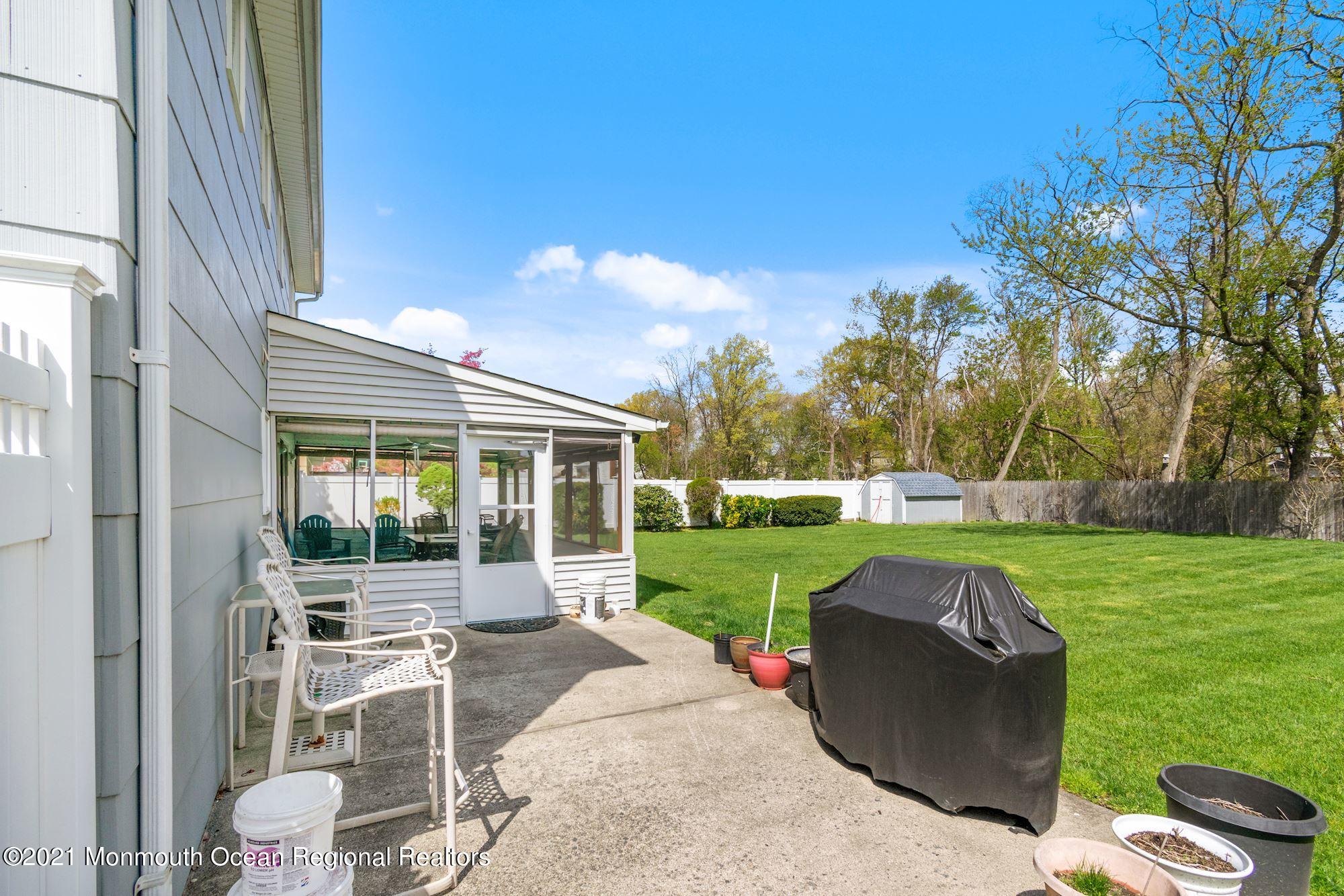 20 Bunkerhill Road Hazlet, NJ 07730 - Photo 27 of 27 a view of a patio with couches chairs and a big yard