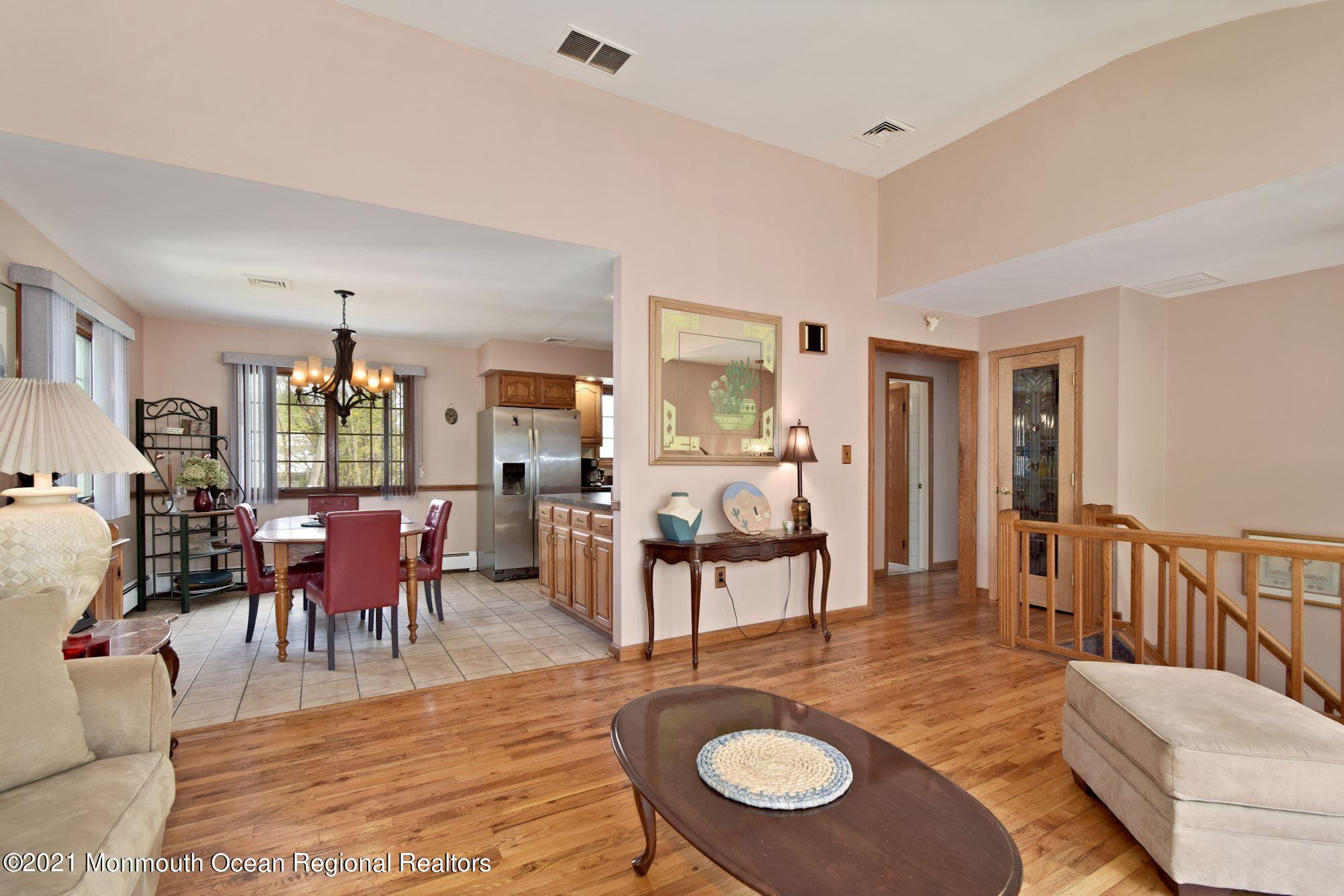 20 Bunkerhill Road Hazlet, NJ 07730 - Photo 5 of 27 a living room with furniture dining table and a chandelier
