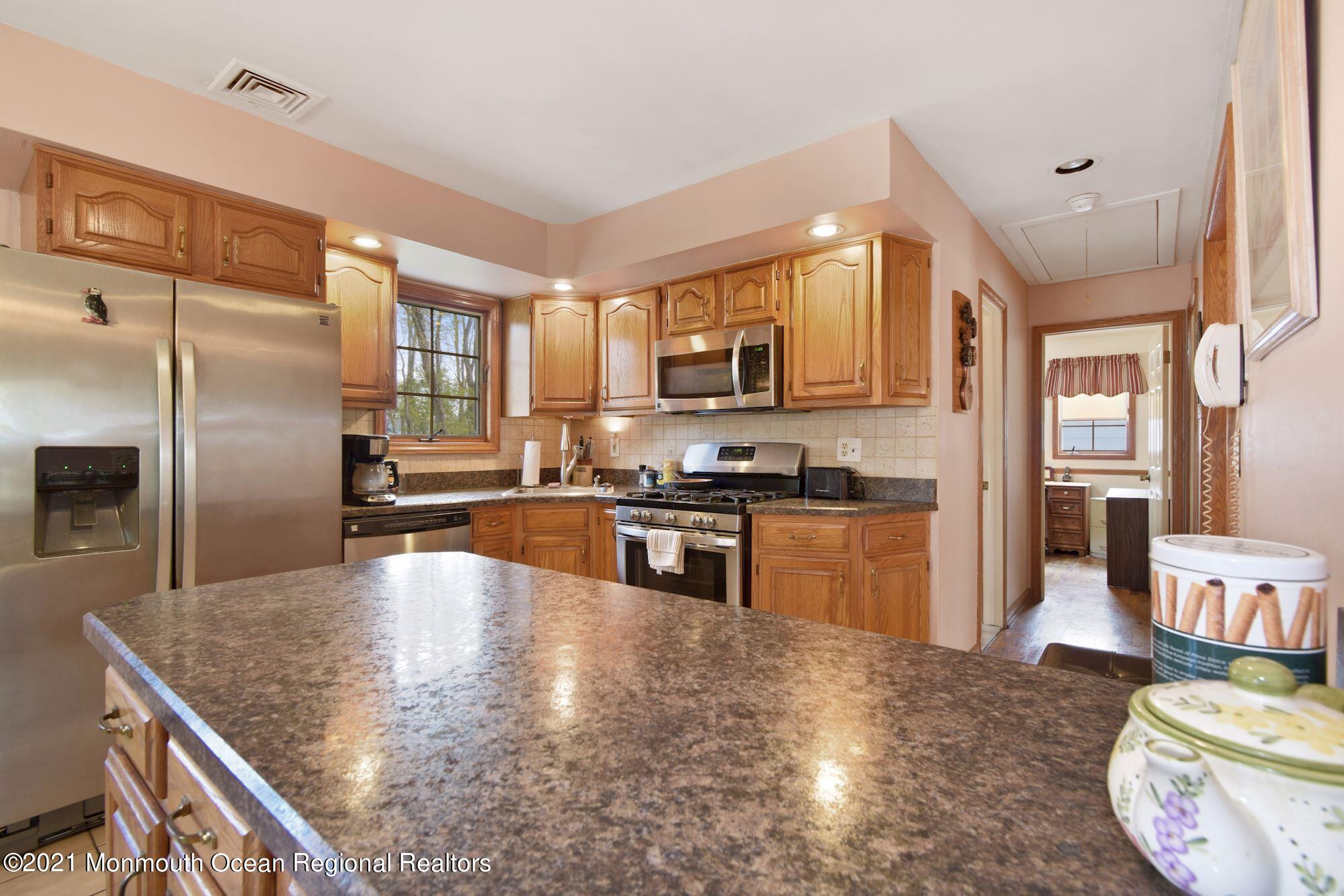 20 Bunkerhill Road Hazlet, NJ 07730 - Photo 7 of 27 a kitchen with stainless steel appliances granite countertop a sink a stove and a refrigerator