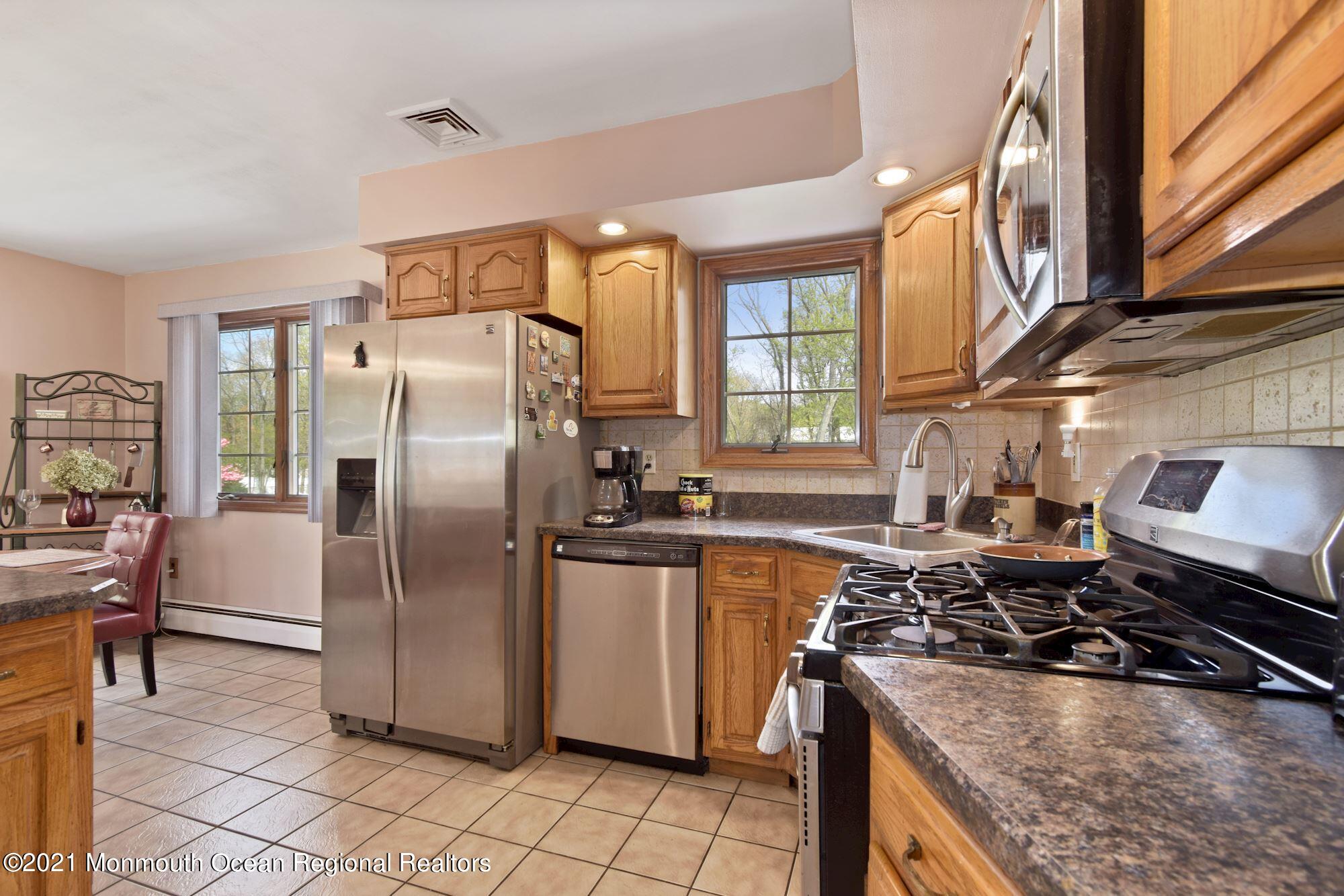 20 Bunkerhill Road Hazlet, NJ 07730 - Photo 8 of 27 a kitchen with stainless steel appliances granite countertop a stove a refrigerator and a sink