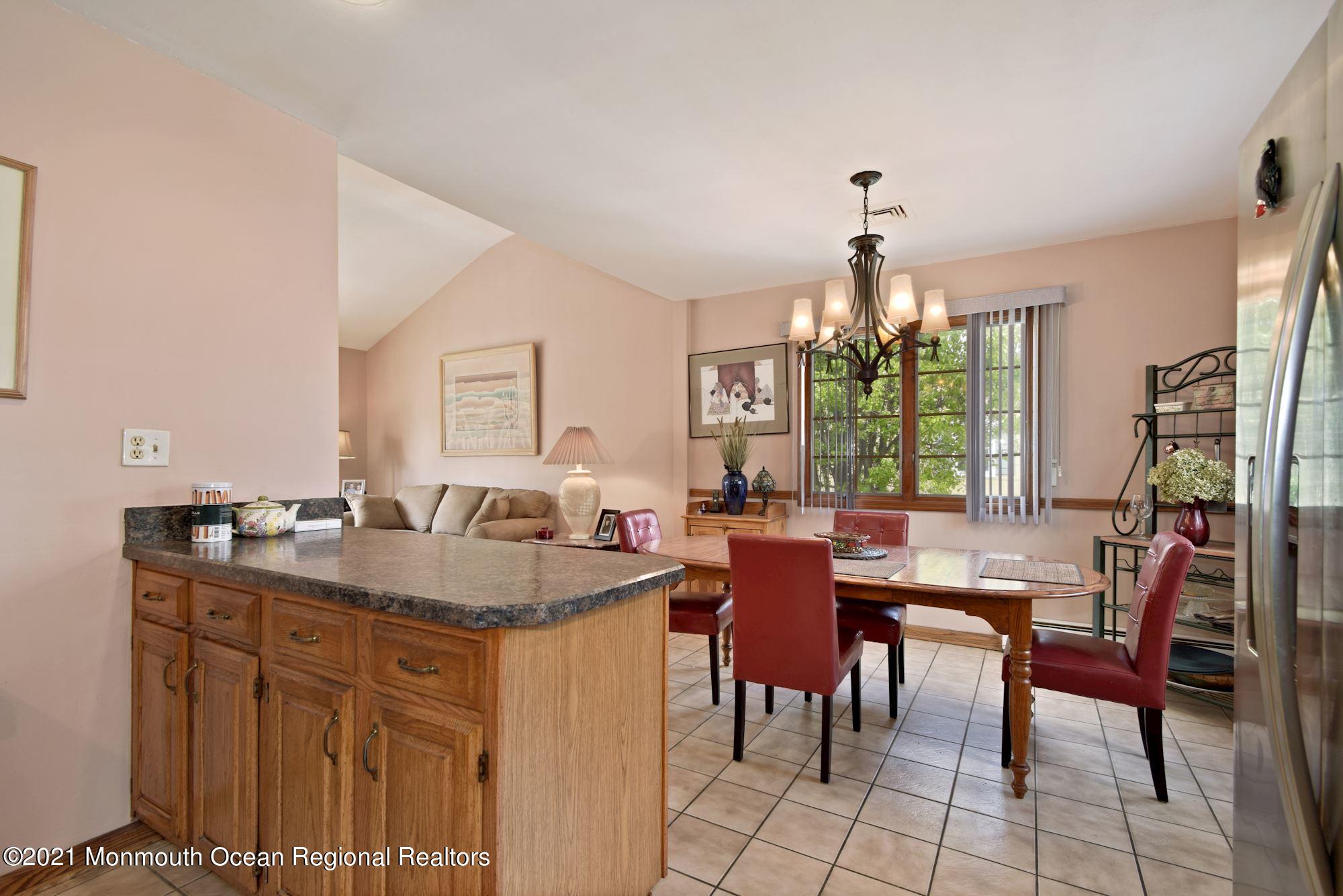 20 Bunkerhill Road Hazlet, NJ 07730 - Photo 9 of 27 a dining hall with granite countertop a sink dishwasher a dining table and chairs with wooden floor