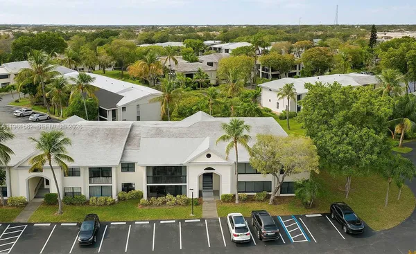 an aerial view of a house with swimming pool garden view and lake view