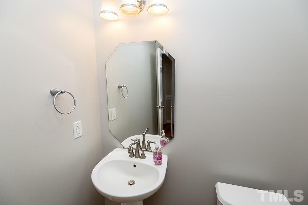 5016 Big Creek Road Raleigh, NC 27613 - Photo 11 of 25 a bathroom with a sink and mirror