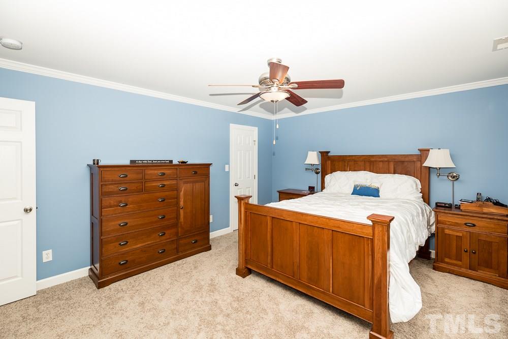 5016 Big Creek Road Raleigh, NC 27613 - Photo 13 of 25 a bedroom with a bed and a dresser