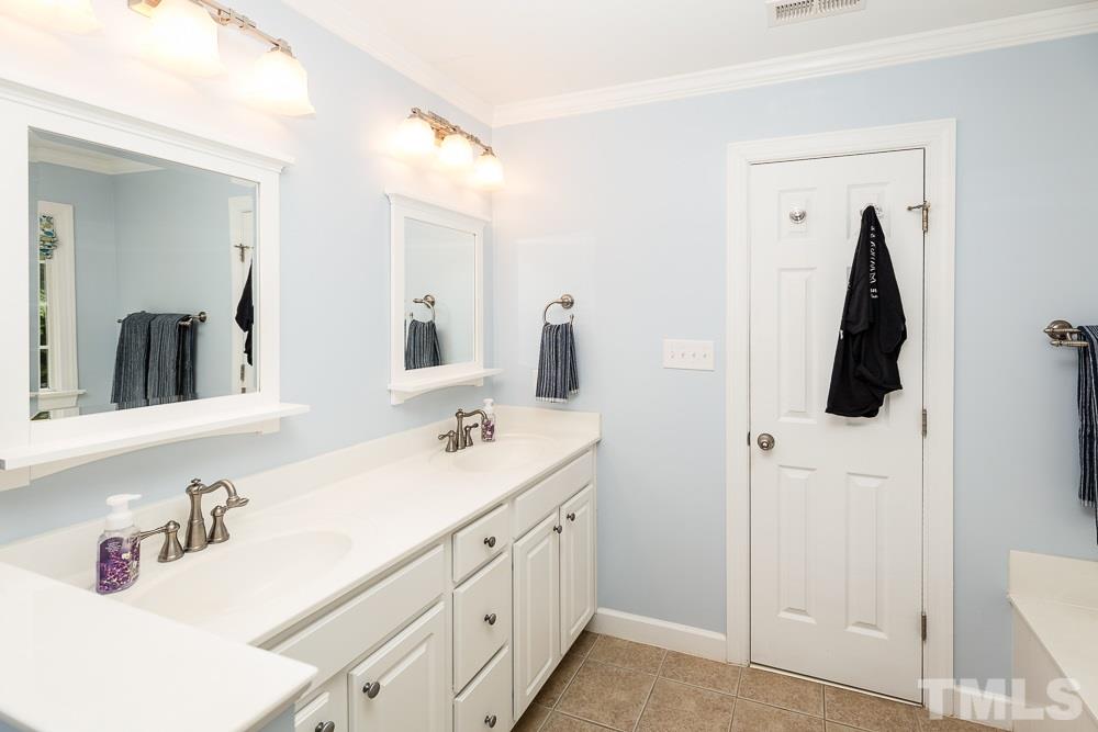 5016 Big Creek Road Raleigh, NC 27613 - Photo 15 of 25 a bathroom with double vanity sink and two mirror