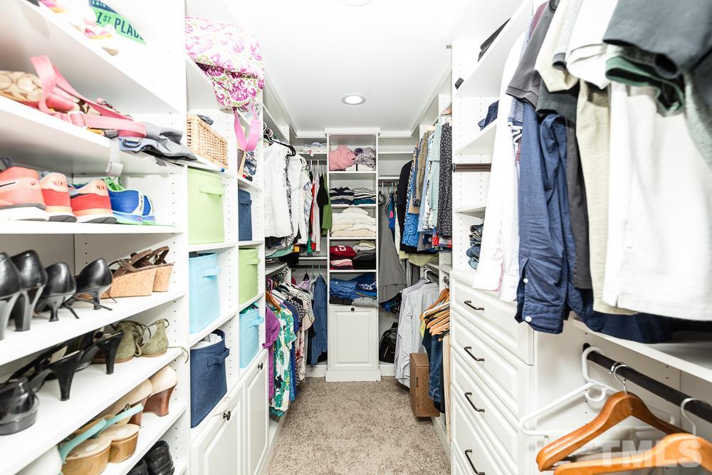 5016 Big Creek Road Raleigh, NC 27613 - Photo 16 of 25 a view of walk in closet with clothes and shoes