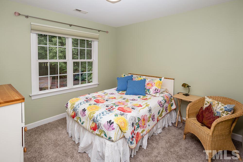 5016 Big Creek Road Raleigh, NC 27613 - Photo 17 of 25 a bedroom with a bed and a window
