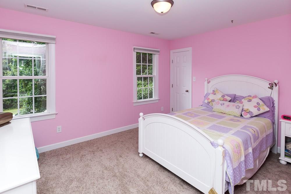 5016 Big Creek Road Raleigh, NC 27613 - Photo 19 of 25 a bedroom with pink walls and pink rug