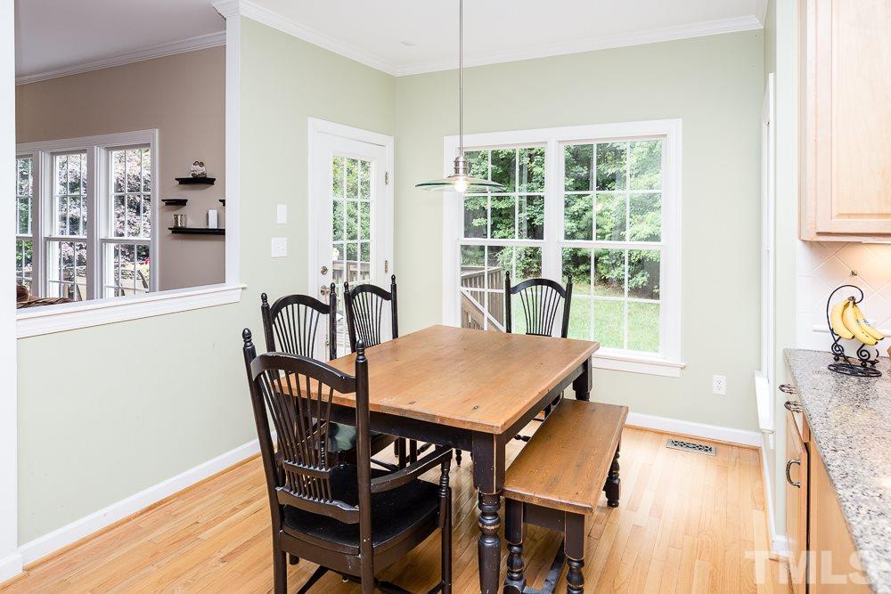 5016 Big Creek Road Raleigh, NC 27613 - Photo 5 of 25 a view of a dining room with furniture window and wooden floor