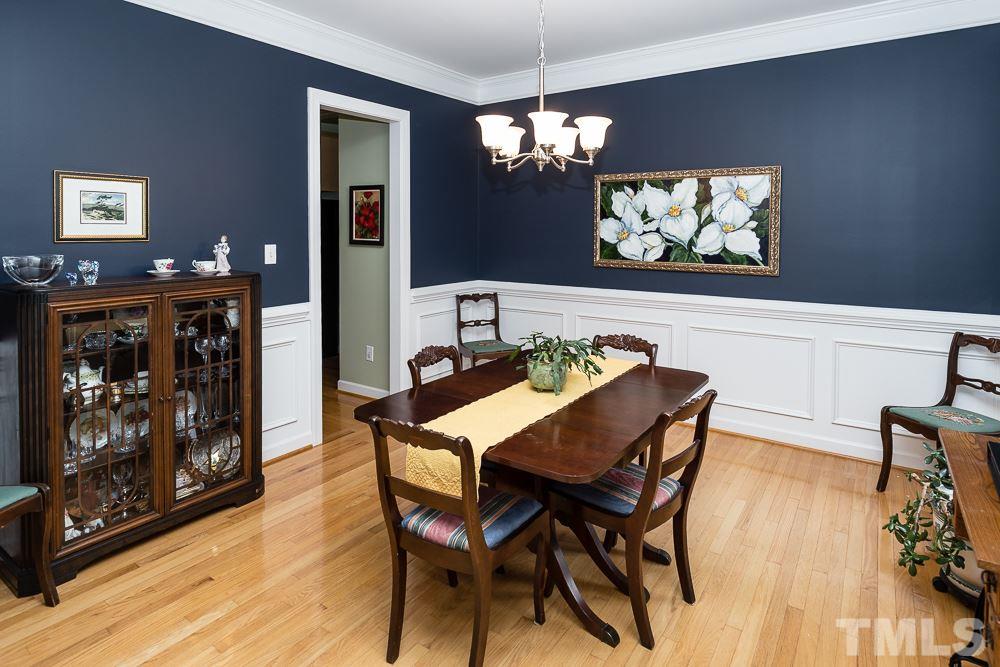 5016 Big Creek Road Raleigh, NC 27613 - Photo 9 of 25 a view of a dining room with furniture wooden floor and a chandelier