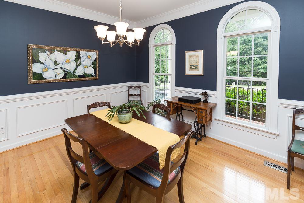5016 Big Creek Road Raleigh, NC 27613 - Photo 10 of 25 a view of a dining room with furniture and a chandelier