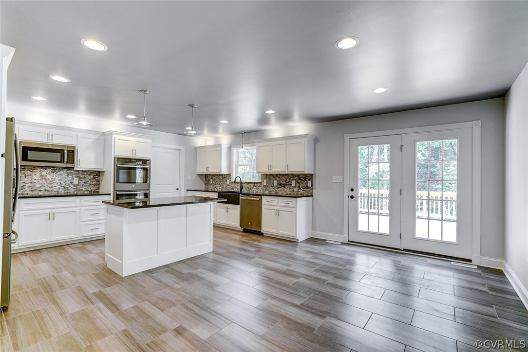 13521 Courthouse Road Dinwiddie, VA 23841 - Photo 11 of 35 a large kitchen with stainless steel appliances granite countertop a large counter top and a stove top oven