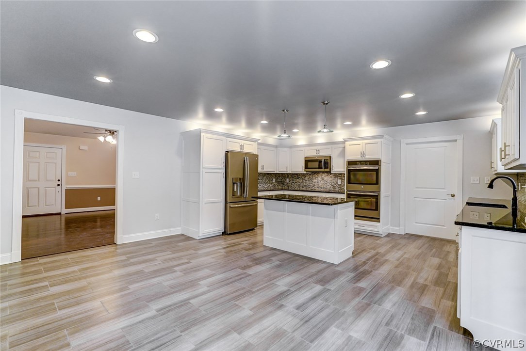 13521 Courthouse Road Dinwiddie, VA 23841 - Photo 12 of 35 a large kitchen with kitchen island a sink stainless steel appliances and cabinets