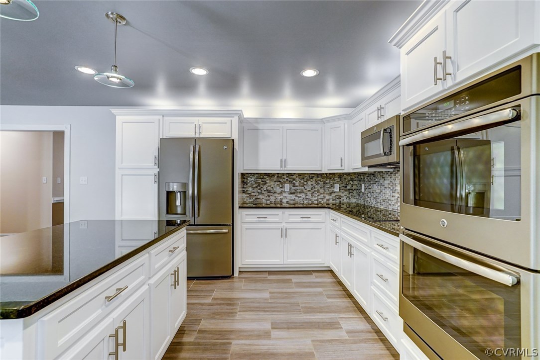 13521 Courthouse Road Dinwiddie, VA 23841 - Photo 16 of 35 a kitchen with granite countertop a refrigerator and a sink
