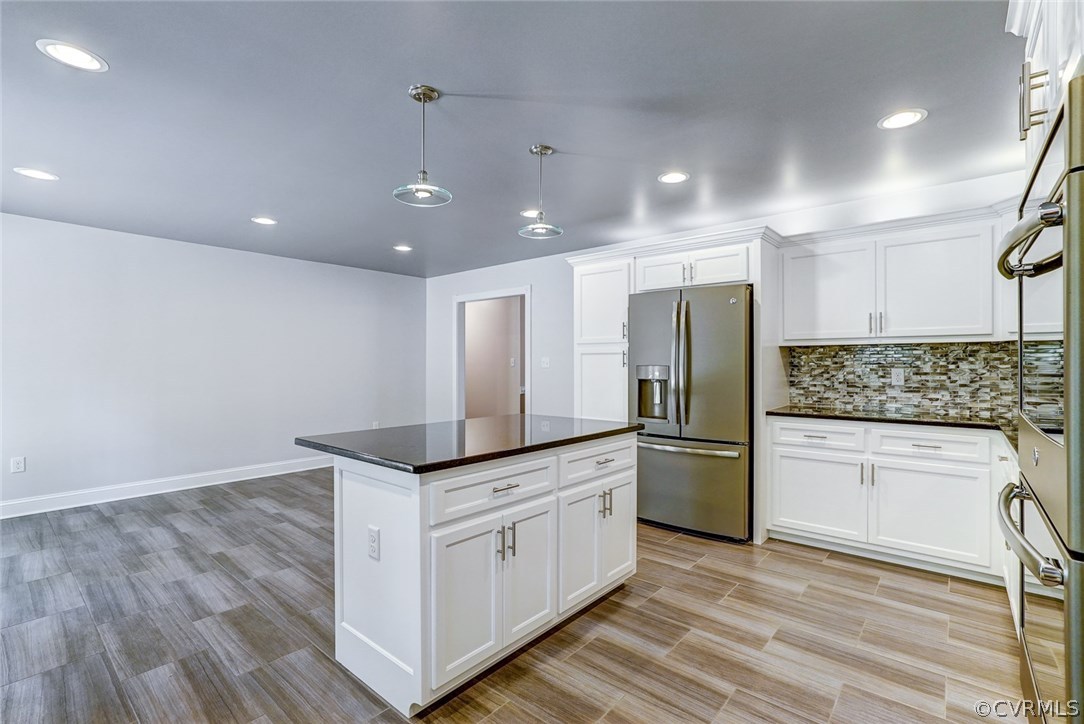 13521 Courthouse Road Dinwiddie, VA 23841 - Photo 17 of 35 a kitchen with stainless steel appliances granite countertop a sink and a refrigerator