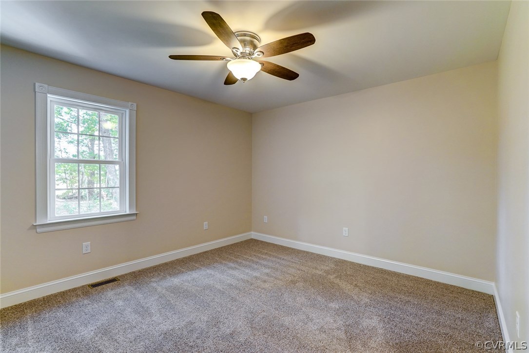 13521 Courthouse Road Dinwiddie, VA 23841 - Photo 23 of 35 an empty room with ceiling fan and windows