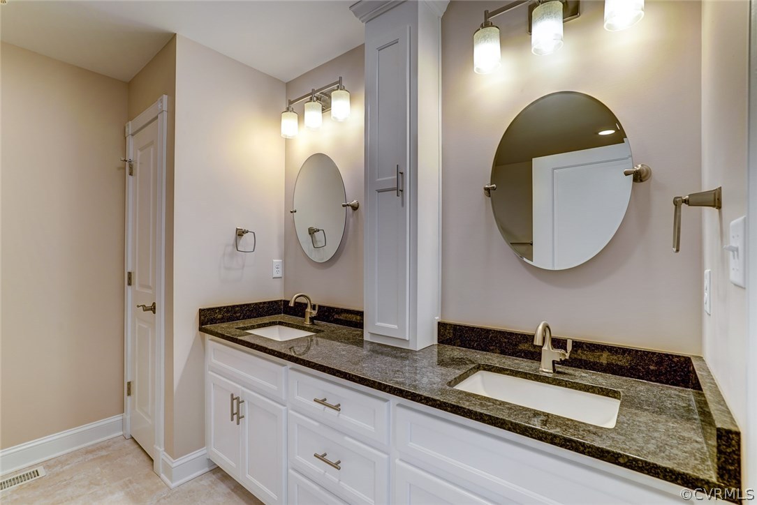 13521 Courthouse Road Dinwiddie, VA 23841 - Photo 29 of 35 a bathroom with a granite countertop double vanity sinks and a mirror