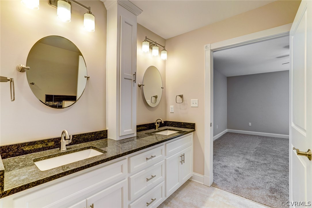 13521 Courthouse Road Dinwiddie, VA 23841 - Photo 32 of 35 a bathroom with a double vanity sink and a mirror