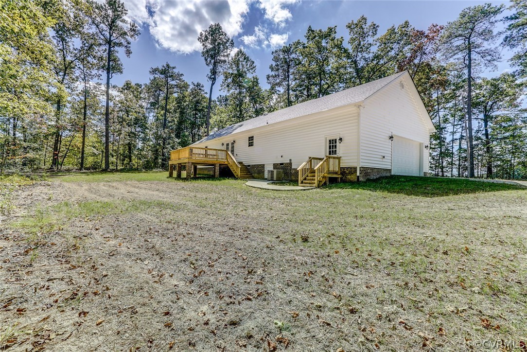 13521 Courthouse Road Dinwiddie, VA 23841 - Photo 4 of 35 a view of a backyard with plants and large trees