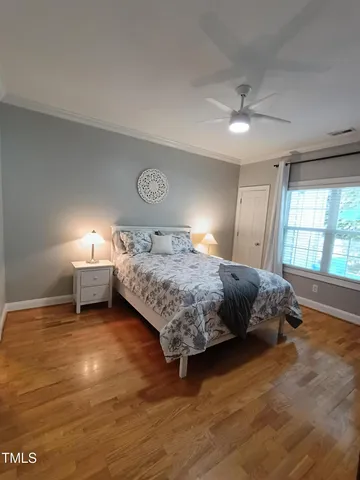 a bedroom with a bed and a potted plant
