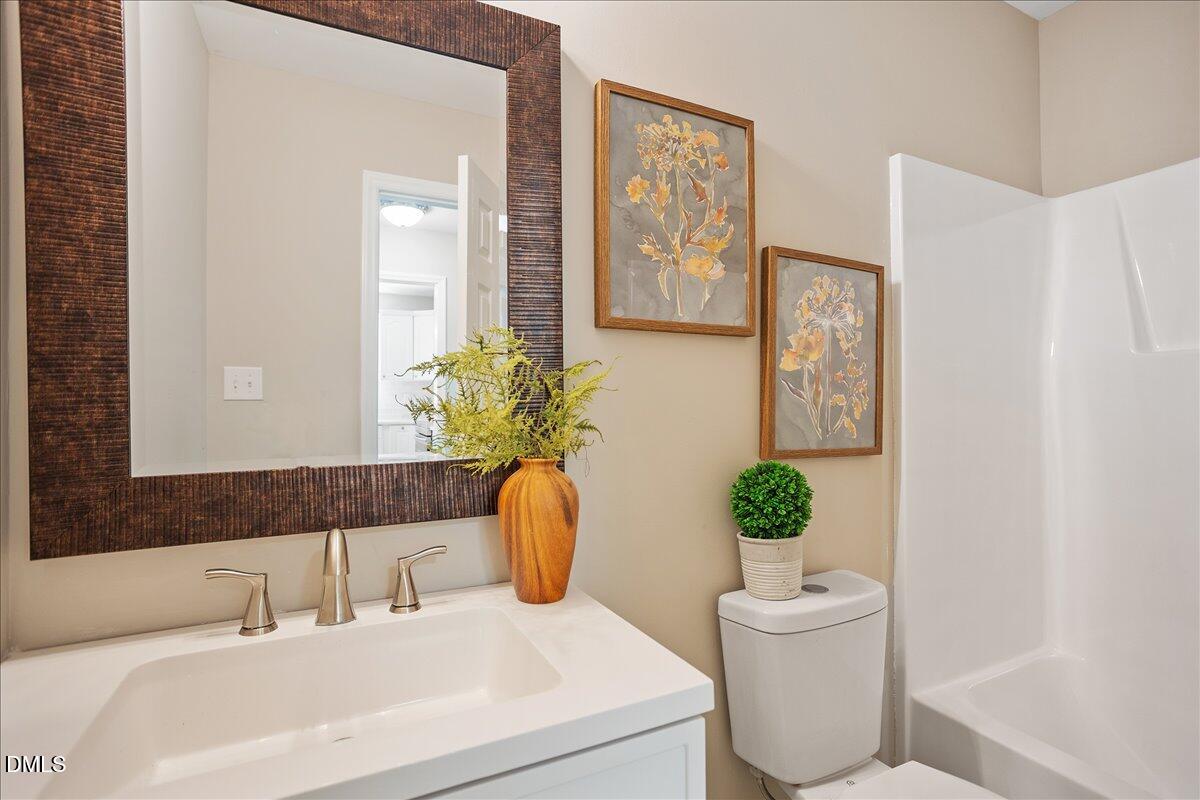 31 Fieldview Court Angier, NC 27501 - Photo 18 of 25 a bathroom with a sink a toilet and a mirror