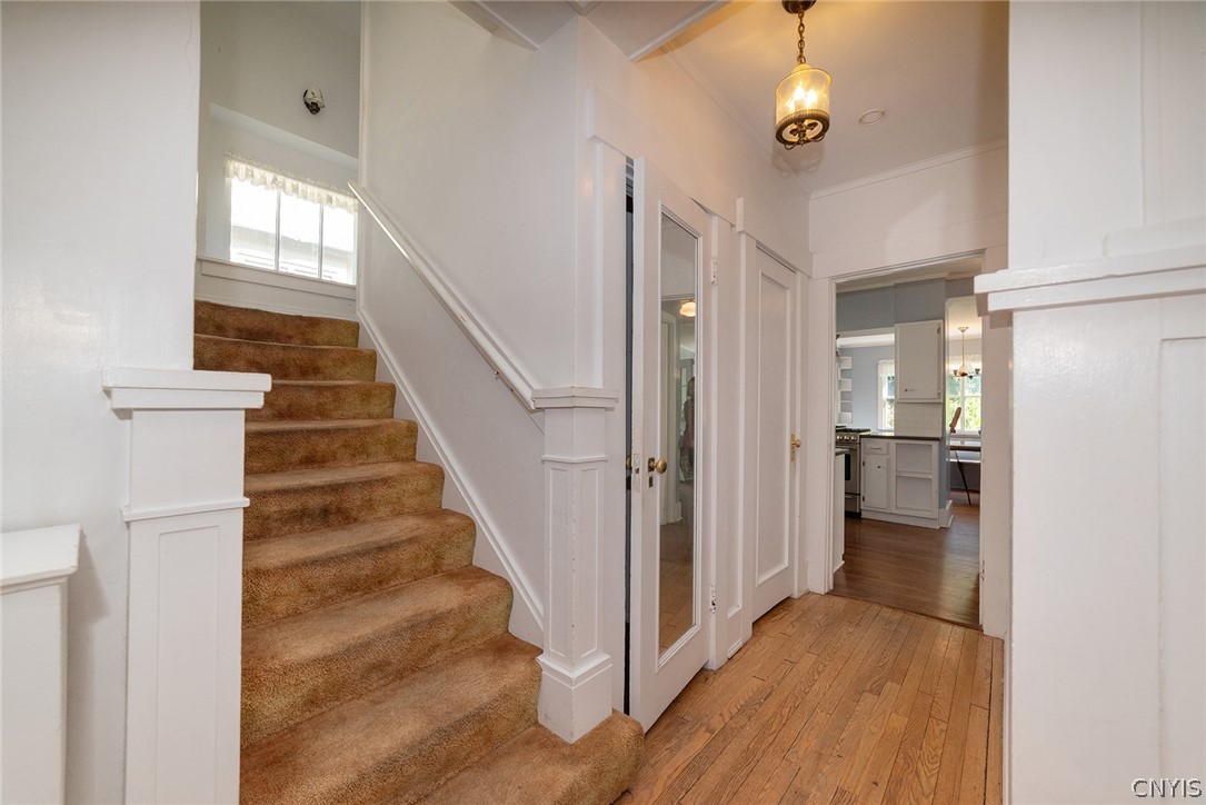 167 Beverly Road Syracuse, NY 13207 - Photo 16 of 50 Hardwood flooring complements classic woodwork and a central staircase in this inviting hallway.